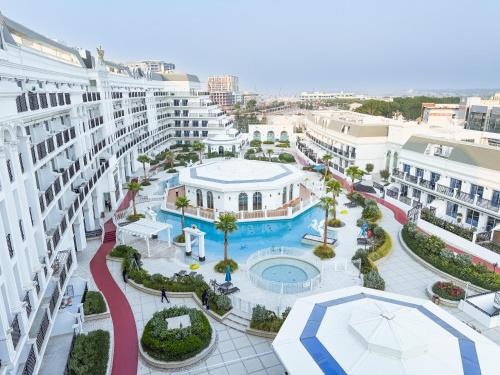 an aerial view of a resort with a pool and buildings at 1BR Lagoon View Luxury Spa Retreat near Miracle Garden By Green Sky Holiday Homes in Dubai