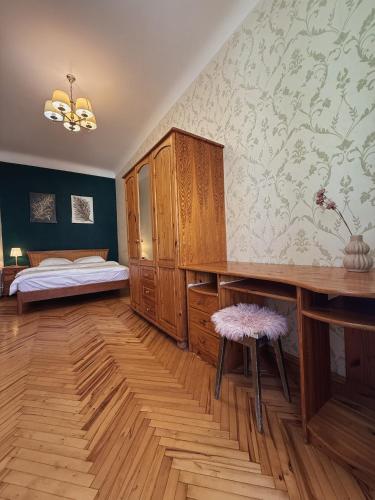 a room with a bedroom with a desk and a bed at Kyiv Sofia Apartment in Kyiv