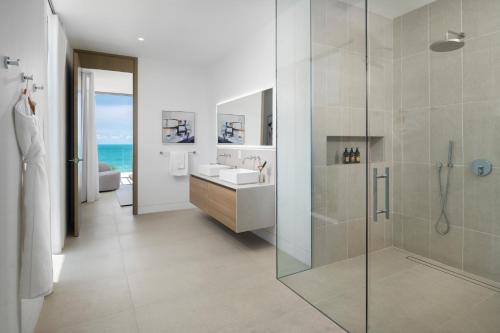 a bathroom with a shower and a sink at South Bank in Long Bay Hills