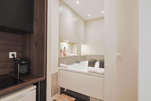 a bathroom with a sink and a counter at LES BULLES DE MONA - Passion - Spa - Clim in Lyon