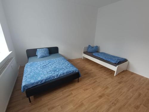 a bedroom with a bed and a bench in it at Large flat with separate rooms for 8 guests ST0 in Zeitz