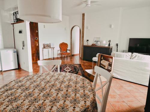 a living room with a table and chairs at Suite Gonzaga in Messina