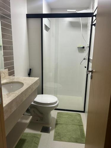 a bathroom with a toilet and a sink and a shower at Park Veredas - Flat 216 in Rio Quente