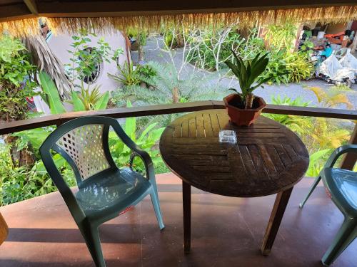 a table and chairs and a potted plant on a balcony at RELAX ECO Life Center-Khao Lak in Khao Lak