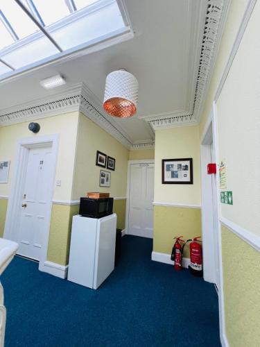 a room with a white refrigerator and a window at Thistle Residence in Edinburgh