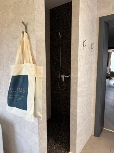 a tote bag hanging on a wall in a bathroom at Lauras in Bauska