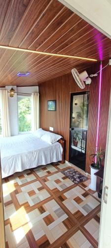 a bedroom with a bed and a wooden ceiling at JK Home stay in Sultan Bathery