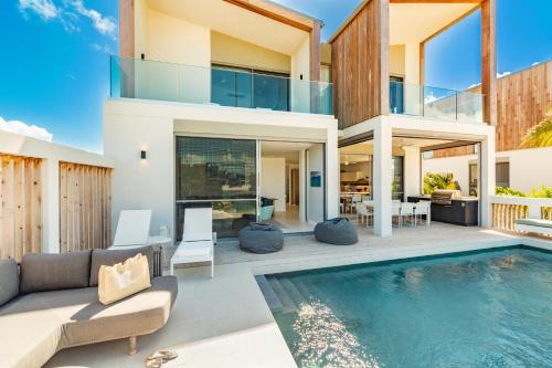an image of a house with a swimming pool at South Bank in Long Bay Hills