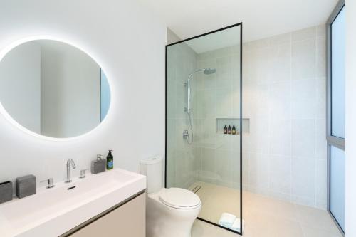 a bathroom with a shower and a toilet at South Bank in Long Bay Hills