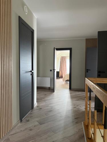 an empty room with a door and a hallway at Lauras in Bauska