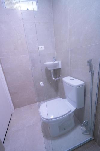 a bathroom with a shower with a toilet and a sink at Flats Regamar in Porto De Galinhas