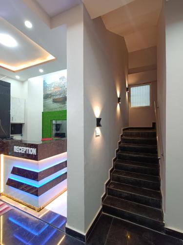 a set of stairs in a lobby with a painting on the wall at Kashi V Homestay in Varanasi
