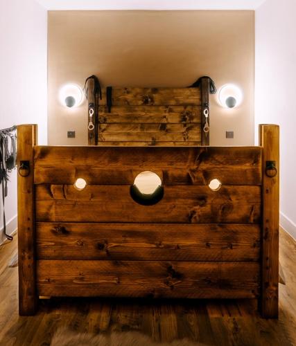 a large wooden chest with lights on top of it at Casa Amor - Adult Only Jacuzzi Suite in Southampton