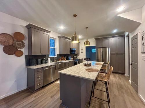 a large kitchen with a island in the middle at New Home! Hilltop Hideaway near Historic Dahlonega in Dahlonega