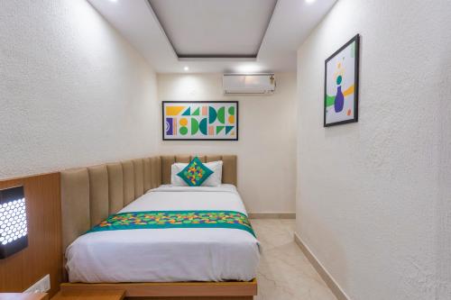 a small bedroom with a bed in a room at Treebo Premium The Regal Park in Visakhapatnam