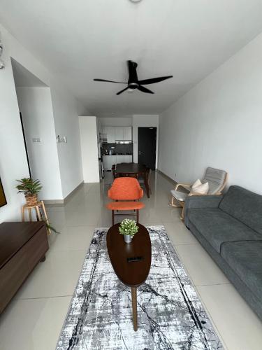 a living room with a couch and a ceiling fan at Appartment Desaru Utama in Bandar Penawar