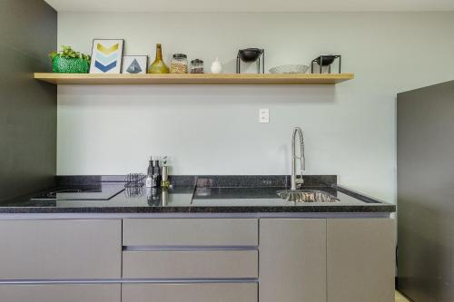 a kitchen with a sink and a counter top at Novíssimo: Go Carlos Gomes - Infra estrutura e Vista Espetacular! in Porto Alegre