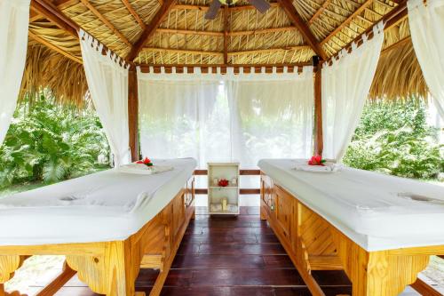 two beds in a bamboo room with a window at CAMPO DEL MAR - STUDIOS and SUITES - LOS CORALES beach in Punta Cana