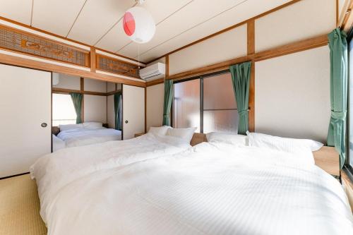 Ένα ή περισσότερα κρεβάτια σε δωμάτιο στο Kasai Hotel near Shinjuku, Akihabara, Asakusa TDR-Disney T-LAB 一棟まるまる葛西ホテル最大9名