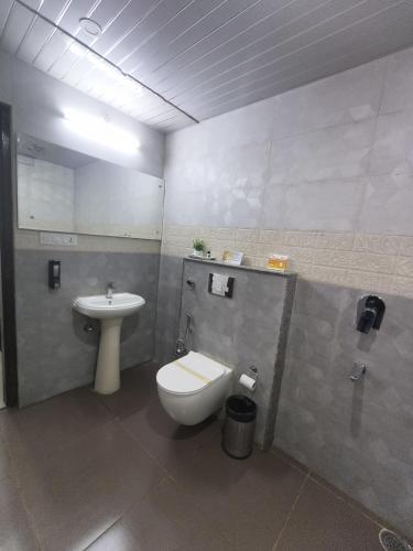 a bathroom with a toilet and a sink at Aliza Inn And Suites By SRS Hotels in Dharamshala