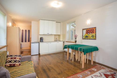 a living room with a table and a kitchen at Small House in Trakai Oldtown 1-6 sleeping places in Trakai