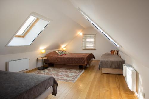 a attic room with two beds and a window at Small House in Trakai Oldtown 1-6 sleeping places in Trakai