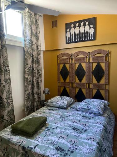 a bedroom with a bed with a blue comforter at Chambres d'hôtes du domaine des doudous in Saint-Pierre