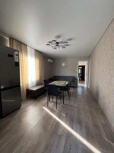 a living room with a table and a couch at Solen in Grigoleti