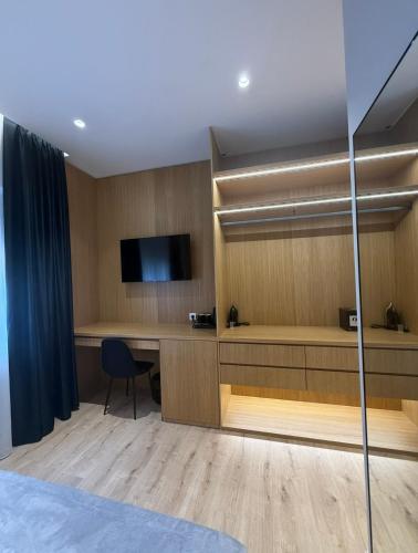 a hotel room with a desk and a television at 4 Rooms Tirana in Tirana