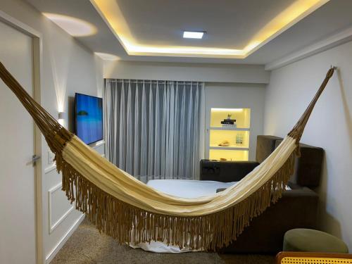 Μια τηλεόραση ή/και κέντρο ψυχαγωγίας στο Flat av beira mar lindo e aconchegante