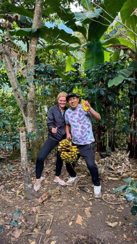 two people posing for a picture in front of a tree at Lia B&B Lucmabamba in Sahuayacu