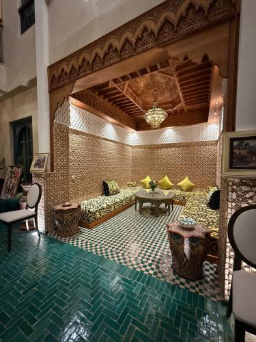 a living room with a couch and a table at Riad Atrium & Spa in Marrakech
