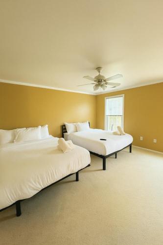 a bedroom with two beds and a ceiling fan at Lawrence RIdge in Adamstown