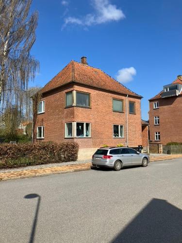a car parked in front of a brick house at Bright and spacious 3 bedroom with balcony close to the city in Aabenraa