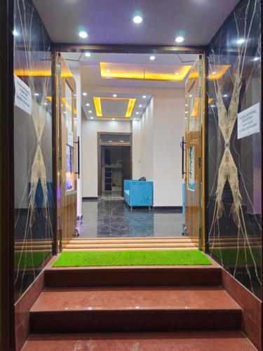 a lobby with stairs with grass in the middle at Kashi V Homestay in Varanasi