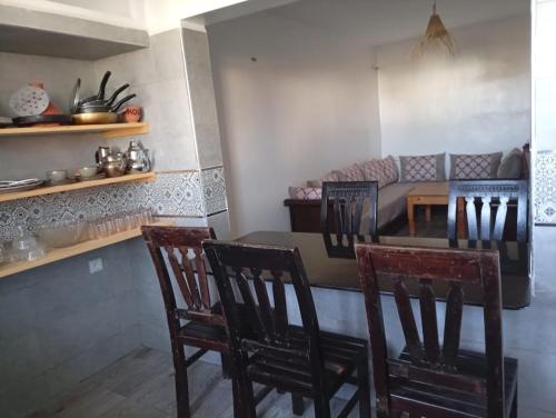 a kitchen with a table and chairs and a couch at Maison Fatima in Essaouira