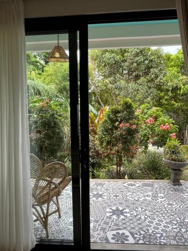 a sliding glass door to a patio with a chair at Casa Nemo Beach Resort & Spa in Sabong
