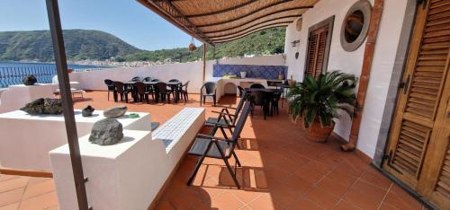 a balcony of a house with a table and chairs at Case vacanza Eolie in Canneto