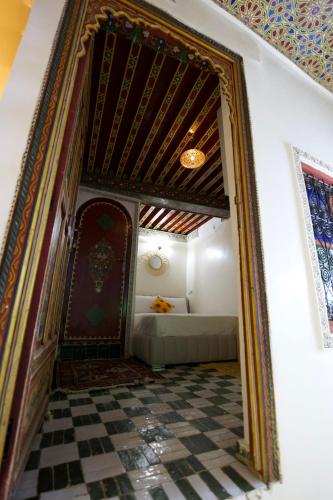 an ornate doorway to a room with a checkerboard floor at Riad Qobbat Zaouïa in Fez
