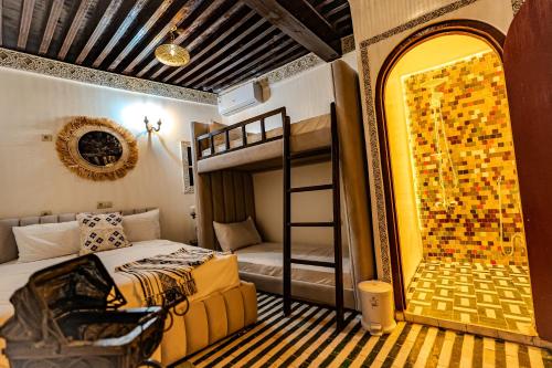 a bedroom with a bed and a bunk bed at Riad Qobbat Zaouïa in Fez