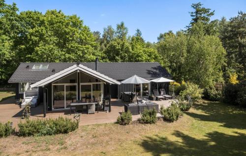 a house with a deck and a patio at Gorgeous Home In Rørvig With Sauna in Rørvig
