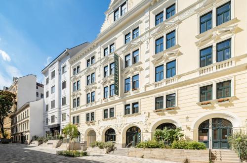 a large white building on the side of a street at Hotel Josefshof am Rathaus in Vienna