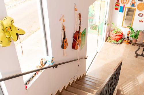 a staircase in a house with guitars on the wall at Pousada Passarada - Tudo novinho te esperando in Pirenópolis