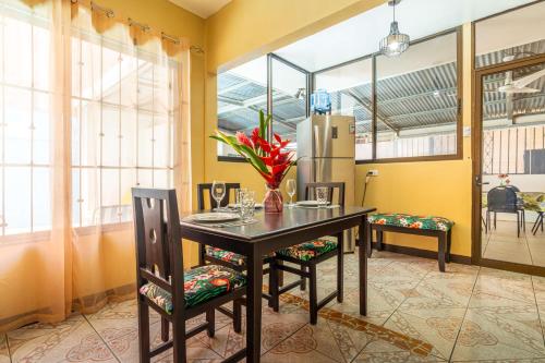 a dining room with a table and chairs and a refrigerator at Fun! Great Location-near Beaches-shopping-medical in Parrita