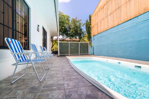 a group of chairs sitting next to a swimming pool at Fun! Great Location-near Beaches-shopping-medical in Parrita