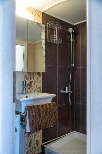 a bathroom with a sink and a mirror at Eagles Nest Panoramic SeaView Apartment in Thérissos