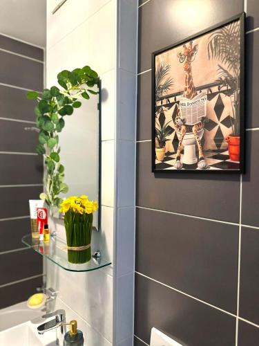 a bathroom with a mirror and a sink at Apartman Bloom in Sarajevo