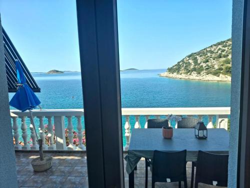 a view of the ocean from a balcony at Apartments Uvala Murtar in Jezera