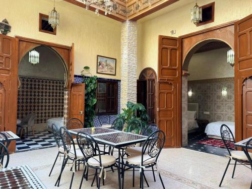 a dining room with a table and chairs at Riad Shama in Rabat