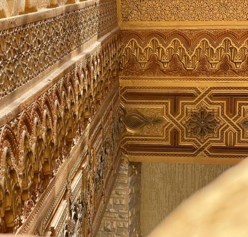 an ornate ceiling of a building with gold at Riad Shama in Rabat